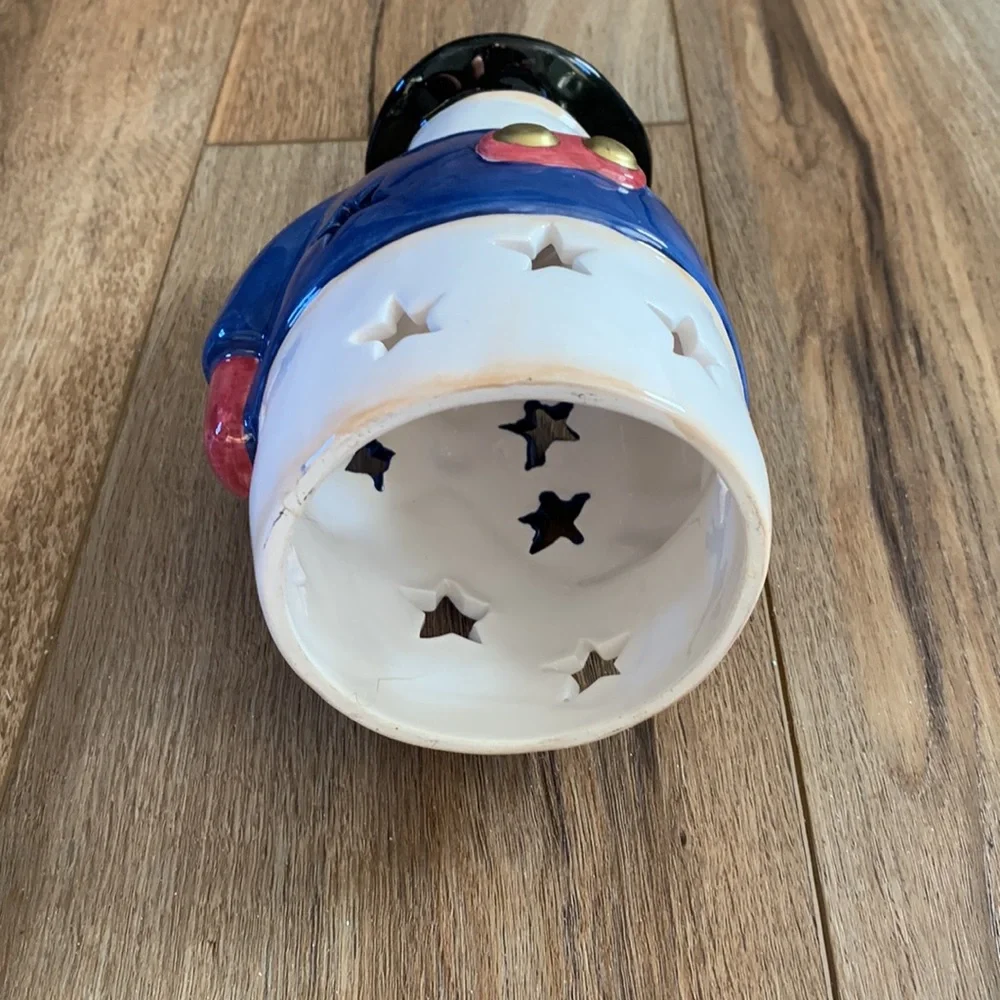 Snowman decor used as Christmas tree topper but think you can put light inside